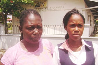 La Toya Poole (right) blood evident on her shirt collar, with her aunt Lorna Hope