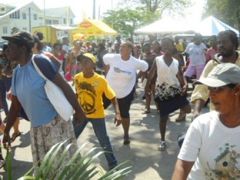 Participants being taken through an aerobics workout session conducted by local fitness guru Curtis McKenzie at the Caribbean Wellness Day health awareness fair at the Merriman’s Mall, Bourda. Jennifer  Gulliver (centre with T-shirt and shorts) won a Nestlé hamper for her endurance. She stayed the course of the  exercise regimen.