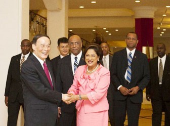 Host CARICOM Head of Government for the Third Caribbean-China Economic and Trade Cooperation forum, Prime Minister Kamla Persaud-Bissessar greets China’s  delegation leader Vice Premier Wang Qishan in Port of Spain earlier this week 