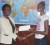 In  picture from left, June Ann Hyles, Human Resources Assistant, presents the cheque to Hazina Barrett. 