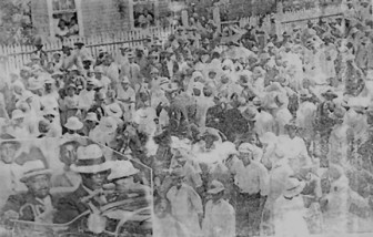 Crowd greets Marcus Garvey on his arrival at the home of Dr S IT  Wills at Lot 190 Charlotte street in Georgetown (October 1937)