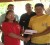 Minister of Amerindian Affairs, Pauline Sukhai presents the monetary support to one of the beneficiaries in the Karasabai Sub-district.
