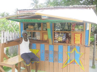 Gairy Croal in front of his shop