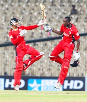 Sunil Narine, left and Kevon Cooper celebrate the Trinidad side’s victory over the Cape Cobras yesterday.