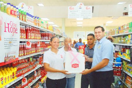 In photo from left to right are Andrea Singh of Toucan Industries, Periwinkle Cancer Care Centre representative Bridget Callender, Champion Pasta Marketing Assistant Satesh Singh and Bounty Supermarket, Water Street Manager Michael Xavier.