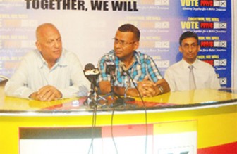 Dr Cheddi (Joey) Jagan Jr (left) and his son Cheddi Berret Jagan II (right) flank Agriculture Minister Robert Persaud at Freedom House last evening during the brief press conference.