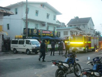 Police officers manning the scene at Rockies Brazilian Bar on Light Street yesterday as firemen contain the situation.