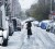 A woman walks down a snow-covered street during an early snow storm in New York October 29, 2011. (Reuters/Lucas Jackson)
