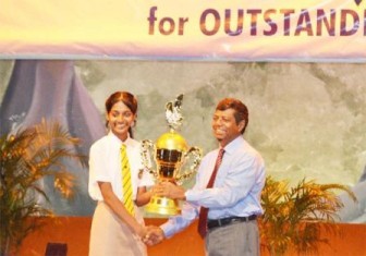 Anuradha Dev receiving her award from Education Minister Shaik Baksh for her overalloutstanding performance at the CSEC this year. (SN file photo)