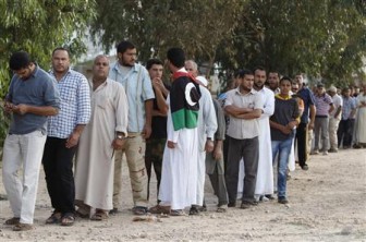 People stand in line to see the body of former Libyan leader Muammar Gaddafi in Misrata today. REUTERS/Saad Shalash