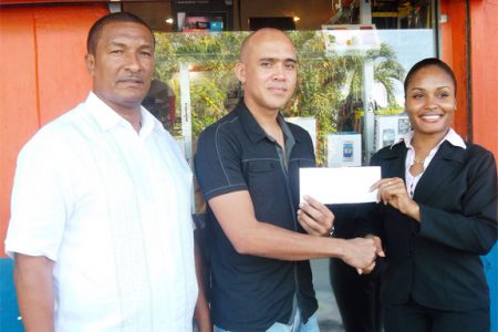 Manager of Cell Phone Shack Christopher Low-Koan (second left) hands overs a cheque to K&S representative Sonia Stanislaus (extreme right) in the presence of K&S Director Kashif Muhammad.