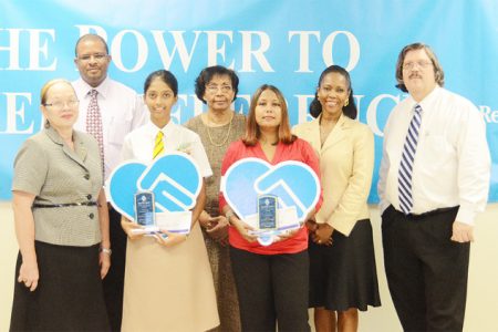 Republic Bank honours top performers: Republic Bank through its ‘Power to Make a Difference Programme’ honoured Anuradha Dev and Kia Persaud for their outstanding performances at the CSEC and CAPE 2011 exams at a special ceremony hosted at its headquarters on Wednesday. According to a press release, Denys Benjamin, Manager-Corporate Operations said the Bank has embraced an overarching vision of youth empowerment through the power to learn and succeed.  He noted that this is demonstrated in a number of reward and developmental initiatives, including for top performers at national examinations. Celine Davis, Manager, Branch Support Services, echoed these statements, adding that the Bank continually seeks ways to honour the nation’s youth and to nurture their potential. Dev and Persaud were given monetary gifts and plaques. The Bank hosted a previous ceremony on July 7 to recognise Terron Alleyne’s outstanding performance at the National Grade Six Assessment 2011. In picture: Dev (second from left in front row) and Persaud’s mother display their plaques as they pose with Bank representatives Patricia Plummer (first from left) and (from left in back row) Benjamin, Yolande Foo, Davis and John Alves. 