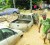 Vehicles, rocks and debris block the roadway yesterday after heavy rains sent torrents of muddy water through Saddle Road, Maraval. These three vehicles were pushed several feet away by flood waters.  (Trinidad Express photo)