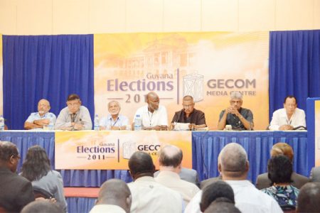 GECOM Commissioners and Chairman flank Chief Election Officer Gocool Boodoo (3rd from right) as he announced the results of Monday’s general and regional elections.  From (l to r) are Mahmood Shaw, Moen McDoom, Bud Mangal, Vincent Alexander, Chairman Steve Surujbally and Robert Williams. Commissioner Charles Corbin was absent from yesterday’s announcement of the results. 