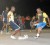 Two players tussle for possession during action in the Guinness-in-the-Streets tournament at the National Cultural Center tarmac  Tuesday evening. (Orlando Charles photo)