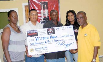 Darshanie Yussuf (second from right), Samuel Blackett (centre) and Sharon Abrams (extreme left) pose for the symbolic handing over of the winning cheque yesterday at Ansa McAl’s headquarters.   