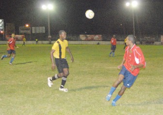 Two players tussle for the ball during the Santos vs Banks DIH All-Stars game. (Orlando Charles photo)  