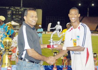 Abuallah Guerra collects the Most Valuable Player trophy from Minister of Sport Frank Anthony. (Orlando Charles Photo)