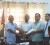 Local Government Minister Ganga Persaud (left) handing over one of the contracts yesterday.
