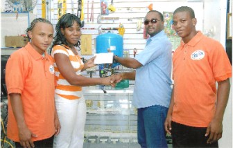 Forging ties! Wayne Forde  (second from right), CEO of Prudential Industrial Technology, hands over a cheque to Candia Shepherd, Treasurer of Fruta Conquerors while  players Marco Marcus (left) and Eon Alleyne look on. 