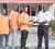 Supervisor of Bayridge Taxi Service Cleveland Conway hands over the prize to Fruta Conquerors Captain Eon Alleyne in the presence of teammates (from left) Tavis Hackett and Dennis Edwards recently.    