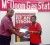  In the picture above, Imhoff, left, hands over a cheque to Haji Fraser of Thomas United for the Mash Challenge Cup.