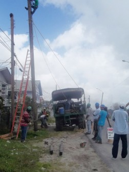 Guyana Power and Light (GPL) technicians working to restore the utility pole and power at Covent Garden yesterday. 