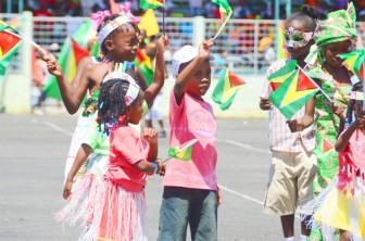 I am a Guyanese: Pupils waving their flags on the National Park tarmac on Saturday last during the Children’s Mashramani Float Parade (Photo by Anjuli Persaud)