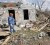 A resident of Henryville, Indiana, surveys what is left of her home yesterday. (Reuters/John Sommers)