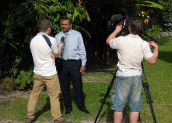 International Boxing Association (AIBA) film producer Stephen King interviewing Minister of Sport Dr Frank Anthony yesterday at the Sports Ministry. (Orlando Charles photo)