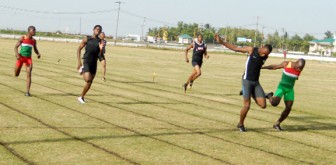  Patrick King (second right) narrowly defeats his club mate Akeem Stewart in a stiff men’s 200 metres final yesterday. (Orlando Charles photo)