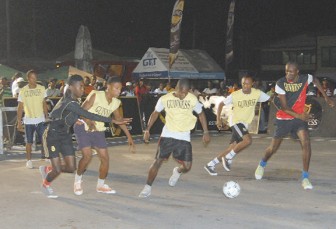 A mid-fielder on the ball sizes up his passing options during the second night of action in the Linden leg of the Guinness Greatest of the Street Competition.