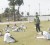 Female cricketers warming down after a match. Coach Orin Bailey is at centre.