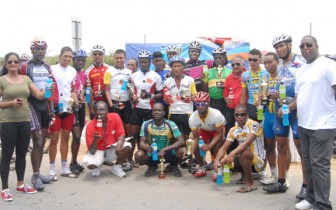 Winners and runners up pose with their Powerade energy drinks and their respective trophies and prizes at the end of the Banks DIH sponsored 50-mile road race yesterday. (Orlando Charles photo)