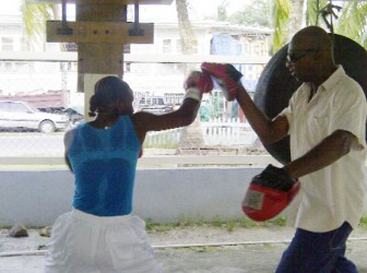 Rewinna David doing padwork outside the Andrew `Sixhead’ Lewis Gym. (Iva Wharton photo)