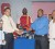Minister of Sport Dr. Frank Anthony hands over a quantity of boxing gear to President of GABA, Steve Ninvalle, while from left, Director of Sport Neil Kumar, Tournament Director of GABA Terrence Poole and Secretary of GABA Shawn Richmond look on. (Orlando Charles photo)