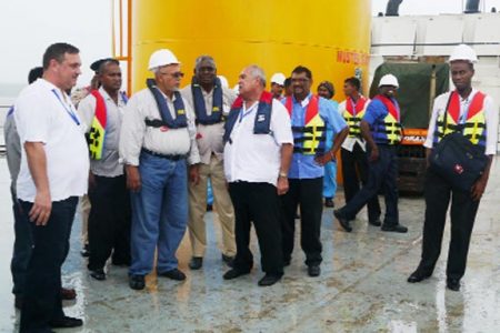 Zakaria El Dib (centre) speaking to President Donald Ramotar during a tour of the operation at the Andrew Basin as Minister Robeson Benn, Regional Chairman, David Armogan and other Oldendorff staff look on