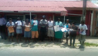 Stall Owners displaying their letters of approval to erect permanent structures in the market centre.