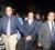 Ian Alleyne (centre) being escorted by a policemen (left) and his attorney (Trinidad Express photo)