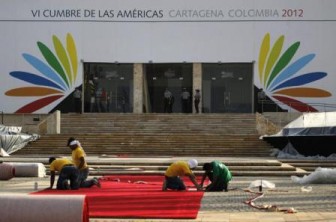 Workers prepare the red carpet at the Centro de Convenciones in Cartagena, Colombia, for the upcoming Summit of the Americas.