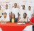 Shonnet Moore (centre sitting) pose with founders of the event Edison Jefford (second from left sitting) and Colin Boyce (second from right sitting) along with Digicel’s Gavin Hope and athletes and coaches standing in the background. (Orlando Charles photo)   