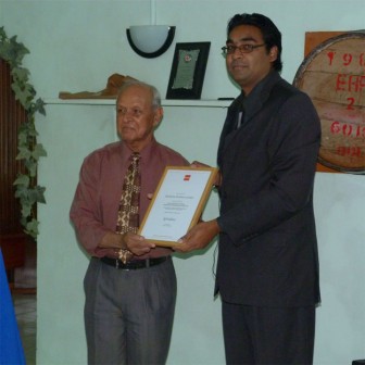  DDL Group Chair Dr Yesu Persaud receives the certificate from Shane Kissoon, Manager ACCA Southern Caribbean (right)