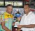 Team CoCo’s Ivan Dominguez accepts the 30th annual three-stage first place trophy from Minister of Sport Dr.Frank Anthony at he prize giving ceremony at the Cliff Anderson Sports Hall yesterday. (Orlando Charles photo)