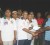 In photo, Lennox John, vice president of DCC, receives the donation from a member of the Guyana Floodlights Softball Cricket Association (GFSCA) while members of the two teams look on.