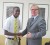 Glinton Hanover being congratulated by Canadian High Commissioner David Devine  