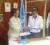 UNDP Resident Representative Khadija Musa (left) and Human Services Minister Jennifer Webster exchange signed copies of the US$75,000 project to support the victims of human trafficking in Guyana and their families.