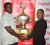 Lyndon Wilson (left) receives the first place trophy for the Police Sports Club