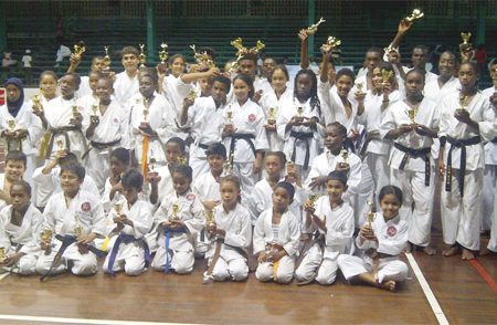 Junior karatekas display their trophies 
