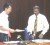 China Machinery Corporation Representative David Huang (left) before he hands the document to Permanent Secretary of the Office of the President, Omar Sharyff. 