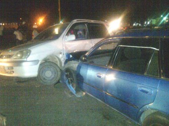 The white Toyota Raum in which the family was travelling after it was repositioned by onlookers to the point of which impact was made with the other vehicle. 